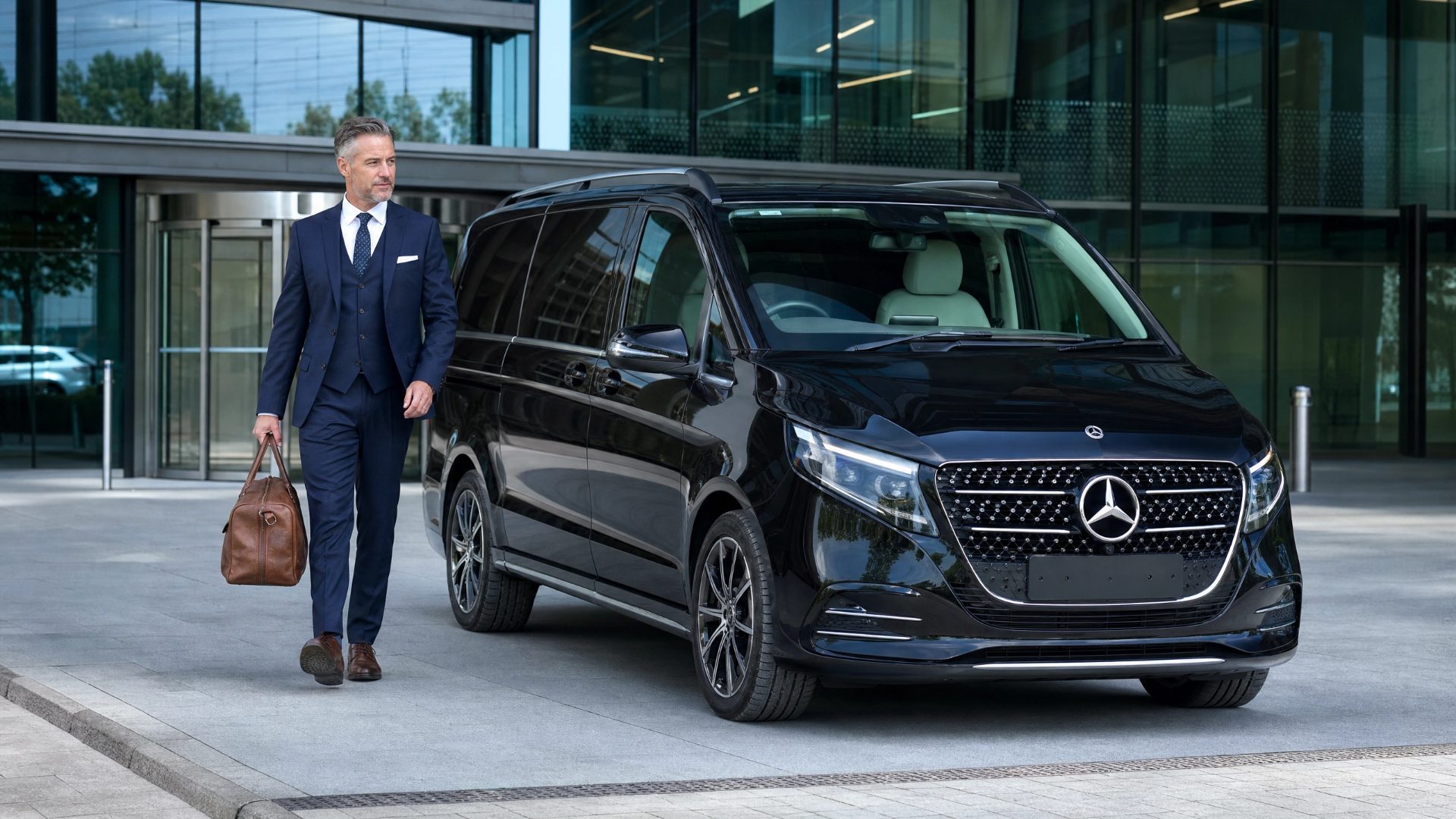 Chauffeur beside a Mercedes-Benz V-Class